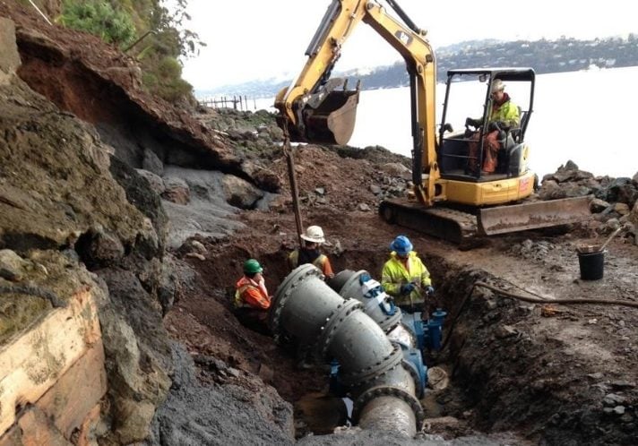 Excavator working on a sewer pipeline.